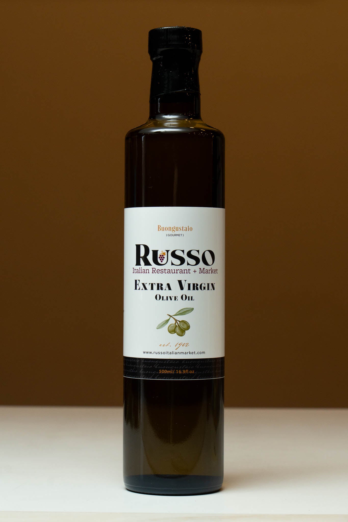 Bottle of Russo Extra Virgin Olive Oil on a brown background