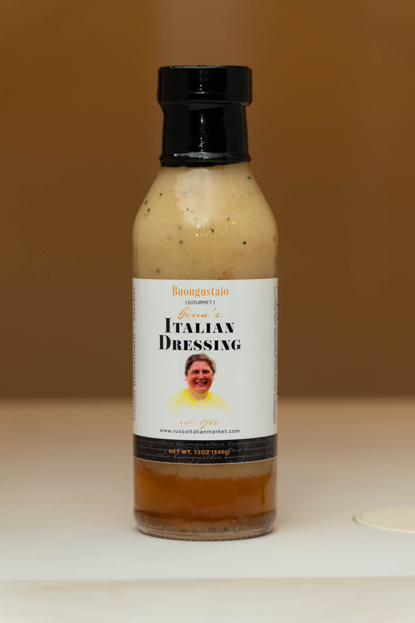 Bottle of Italian dressing with a label featuring a person on a plain background