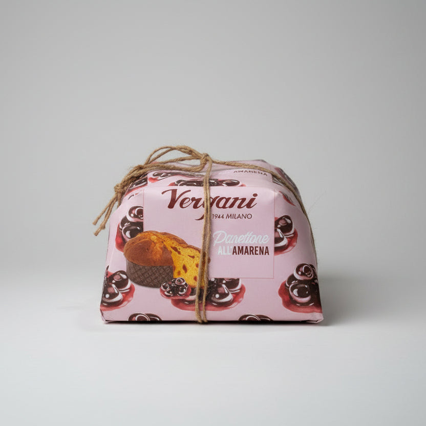Packaged panettone with decorative design on a white surface