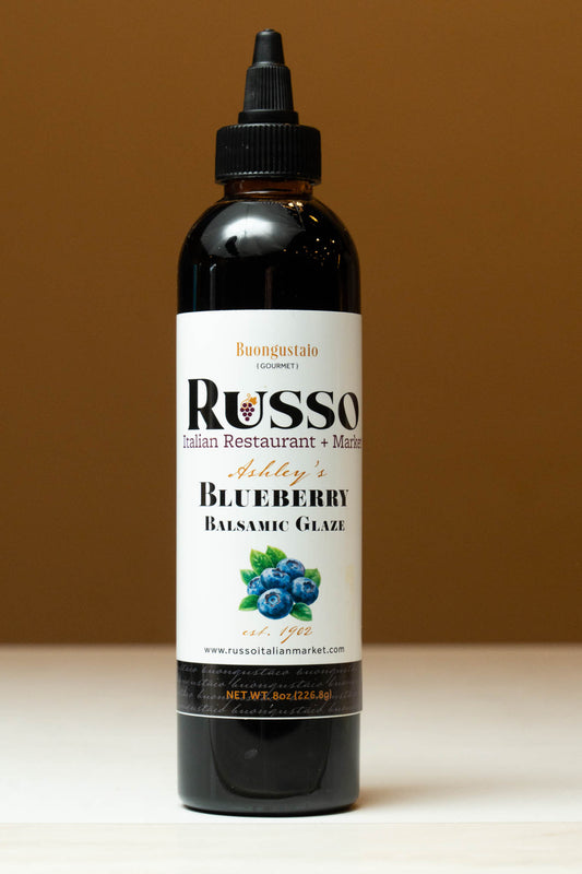 Bottle of Russo Blueberry Balsamic Glaze on a brown background