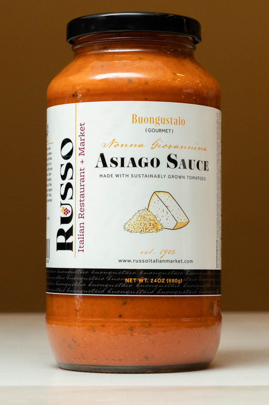 Jar of Russo Asiago Sauce with a label on a brown background