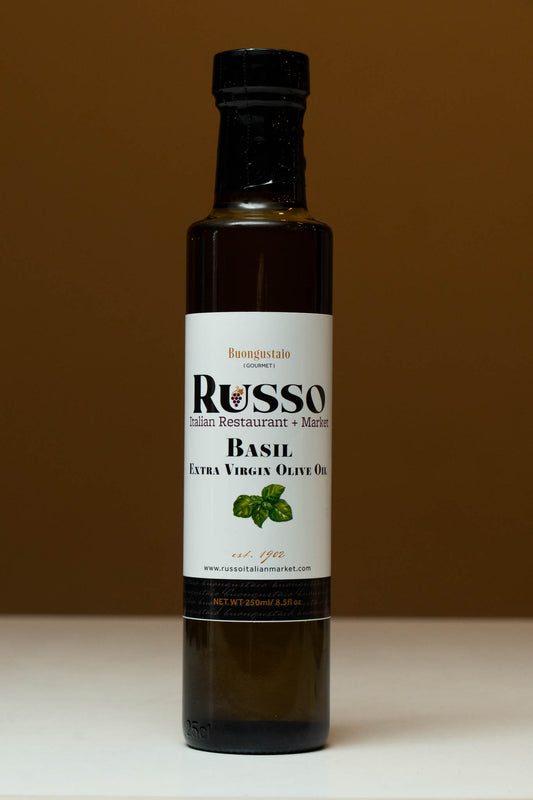 Bottle of Russo Basil Extra Virgin Olive Oil on a brown background