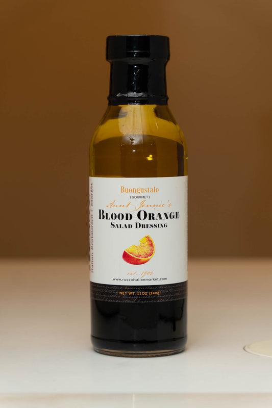 Bottle of Blood Orange Salad Dressing on a neutral background