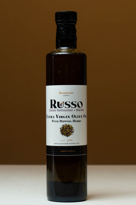 Bottle of Russo Extra Virgin Olive Oil with Dipping Herbs on a brown background