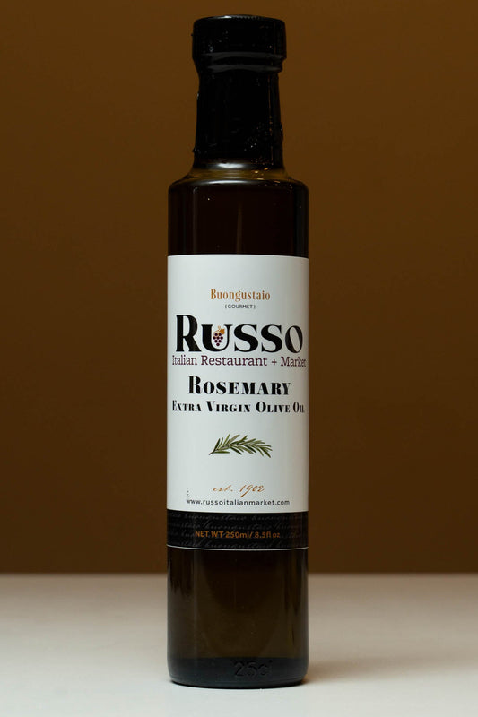 Bottle of Russo Rosemary Extra Virgin Olive Oil on a brown background