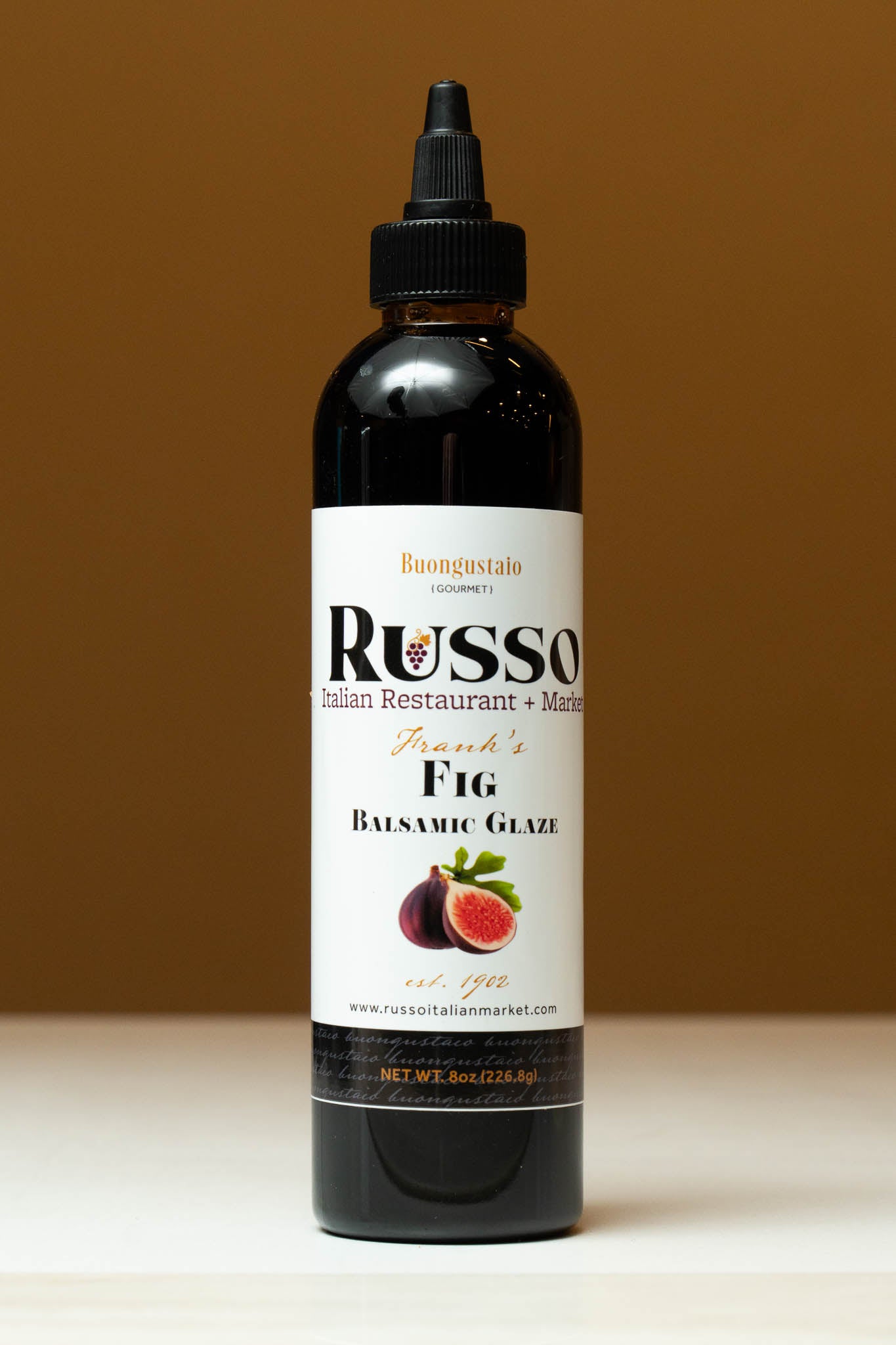 Bottle of Russo Fig Balsamic Glaze on a brown background