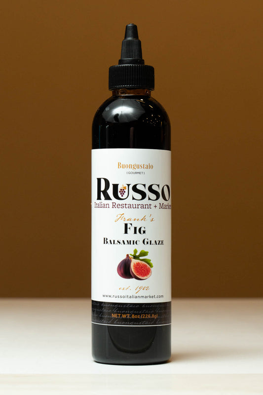 Bottle of Russo Fig Balsamic Glaze on a brown background