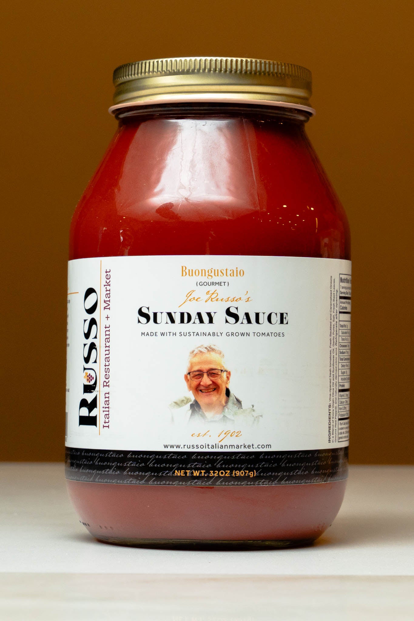 Jar of Russo Sunday Sauce with a label featuring a man's face on a brown background
