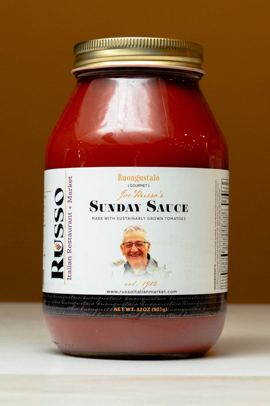 Jar of Russo Sunday Sauce with a label featuring a man's face on a brown background