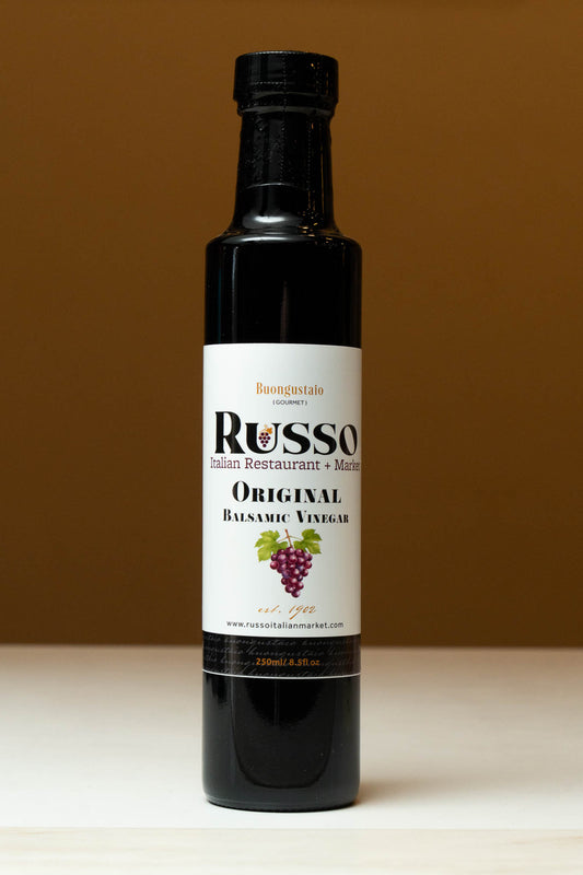 Bottle of Russo Original Balsamic Vinegar on a brown background